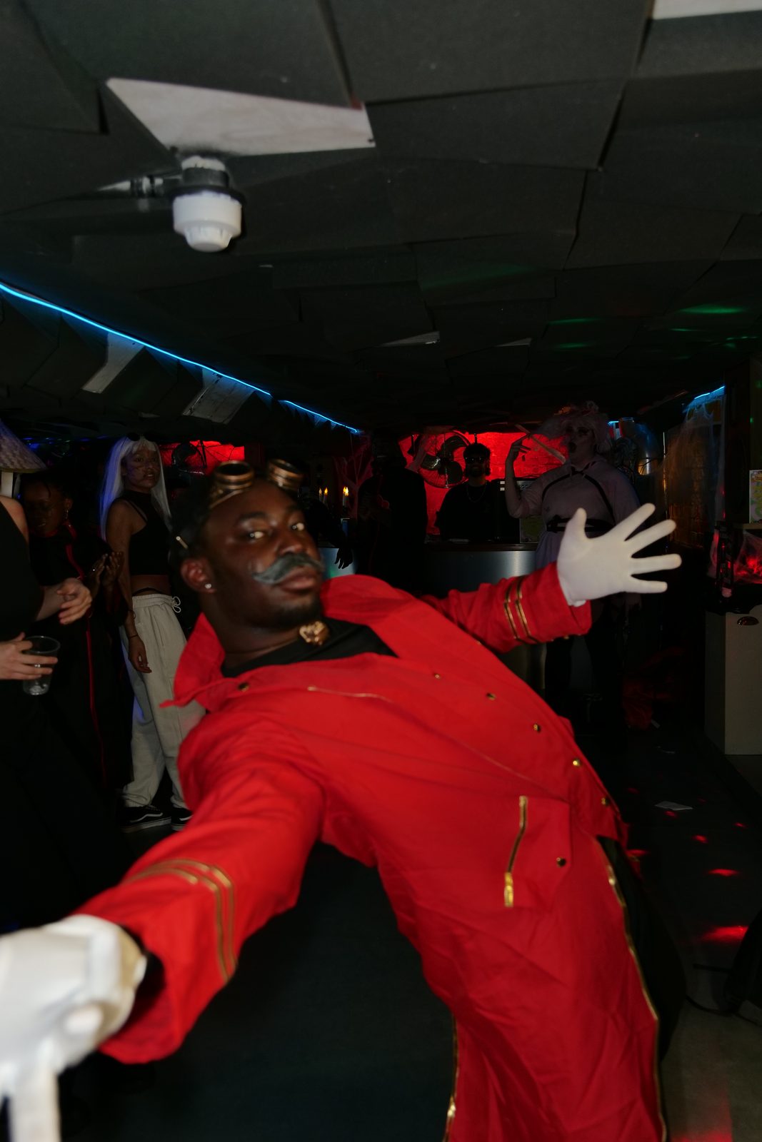 Ambifest attendee in a red steampunk-style cosplay jacket with goggles